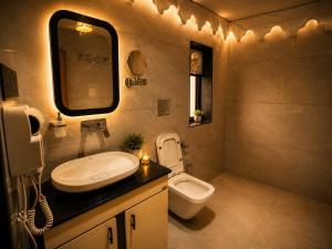 a bathroom with a sink and a toilet at Jawai Garh Resort in Bīsalpur