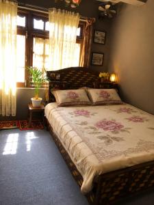 a bedroom with a large bed in a room with windows at Sanjog's B&B in Bhaktapur