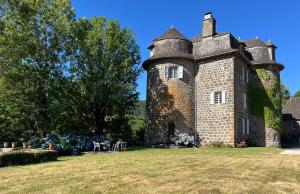 an old castle sitting on a grass field at Château de La Voulte in Marmanhac