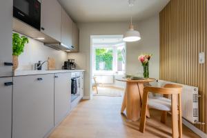 a kitchen with a table and a chair and a table at Rosengarten in Kellenhusen
