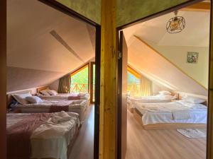 a room with three beds in a room at SymphonyA in Gorists'ikhe