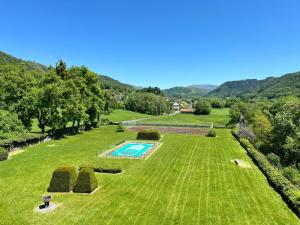 an aerial view of a large grassy field with a swimming pool at Château de La Voulte in Marmanhac