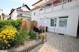 a patio with flowers and plants in front of a house at Haus Steinmeyer in Bad Pyrmont