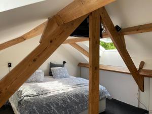 a bedroom with a bed in a attic at TML Music Guesthouse in Aartselaar +37 photos