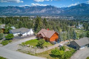 an aerial view of a home with mountains in the background at Mountain View Log Home in Invermere in Invermere