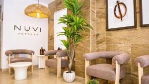 a waiting room with chairs and a potted plant at Nuvi Mercado in Alicante