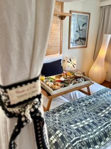 a hotel room with a tray of food on a bed at Oslo Guldsmeden in Oslo +40 photos