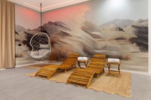 a room with chairs and a mural of a mountain at La Rocca D'amuri - Alma e Aura in Partinico