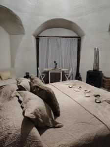 a bedroom with a large bed with pillows on it at Refugio la Resiliencia in Algarrobo +2 photos