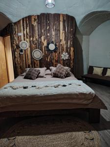 a bedroom with a large bed with a wooden wall at Refugio la Resiliencia in Algarrobo