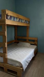 two bunk beds in a room with a white bed at Бухта in Nova Dofinivka