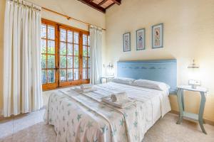 a bedroom with a large bed in a room with windows at Villa 30 m from the beach Cambrils in Cambrils