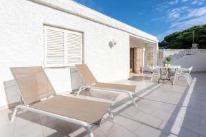 a pair of chairs and a table on a patio at Villa 30 m from the beach Cambrils in Cambrils