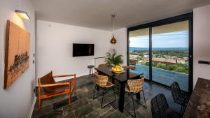 a dining room with a table and chairs at Luxury villa Mar with infinity pool in Rab in Palit