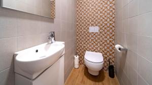 a bathroom with a white toilet and a sink at Luxury villa Mar with infinity pool in Rab in Palit
