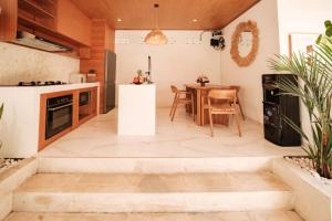 an open kitchen and dining room with a table at Santai Studios in Badung