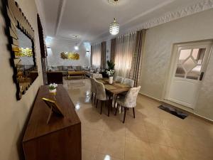 a living room with a table and chairs and a couch at Apartamento Fnideq, Familia, Bienestar y mercado in Riffiene