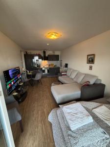 a living room with a couch and a tv at Helle Wohnung in Fürth in Fürth +4 photos