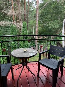 a table and two chairs on a deck with a view at Kompleks Detlafówka in Dębki +15 photos
