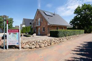 a brick house with a sign in front of it at Haus 50 in Röbel