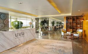 a lobby with a table and chairs in a building at Meliá Yangon in Yangon