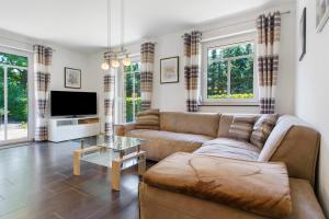 a living room with a couch and a tv at Haus 50 in Röbel