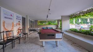 a ping pong table in a room with a pool table at Begonville Hotel in Marmaris