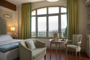 a bedroom with a bed and a table and a window at Torre a Cona Wine Estate in Florence +80 photos