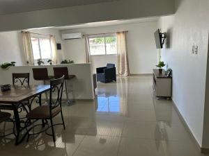 a living room with a table and chairs in it at Hidden Gem Savaneta & Private Pool in Savaneta +8 photos
