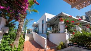 a white building with flowers on the side of it at Begonville Hotel in Marmaris