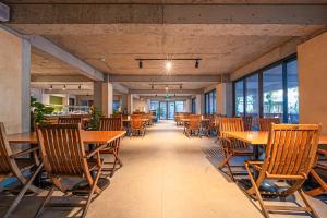 an empty restaurant with wooden tables and chairs at Begonville Hotel in Marmaris