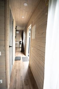 a hallway of a house with a wooden wall at Mērsraga namiņš in Mērsrags