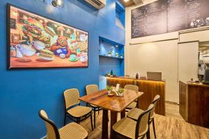 a dining room with a table and chairs in a restaurant at Itsy Hotels Aditya in Nagpur
