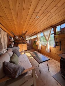 a living room with a couch and a table at Green Bus in Beit Hillel