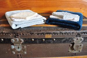 a stack of towels sitting on top of an old suitcase at Château de Mézerville in Mézerville +52 photos