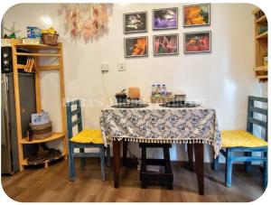 a dining room table with two chairs and a table with a table cloth at Megatower 4 Diorite Unit in Baguio