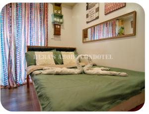 a bedroom with a bed with tworenderedrendered animals on it at Megatower 4 Diorite Unit in Baguio