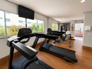 a gym with two treadmills and two exercise bikes at Pumma Business Hotel in Canaã dos Carajás