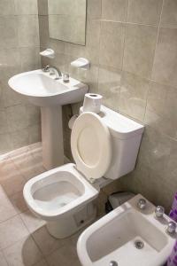 a bathroom with a toilet and a sink at Cabañas Nazareth in Villa Carlos Paz