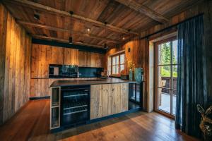 a kitchen with wooden walls and a wooden floor at Alpin Chic by Alpe Chalets in Unterseefeld
