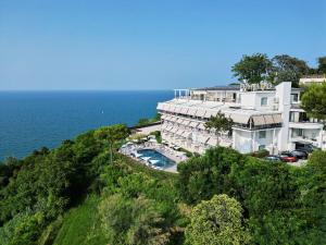Luftaufnahme eines Gebäudes auf einem Hügel neben dem Meer in der Unterkunft Hotel Posillipo in Gabicce Mare