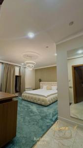 a bedroom with a large bed and a mirror at Radamis in Almaty