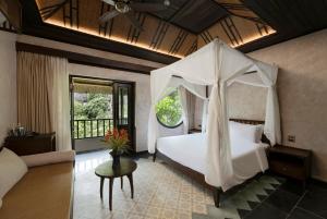 a bedroom with a bed with a canopy at An Hideaway Resort in Ninh Binh