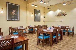 a dining room with wooden tables and chairs at Itsy Hotels Aditya in Nagpur