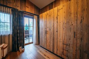 a room with wood paneled walls and a window at Alpin Chic by Alpe Chalets in Unterseefeld +248 photos