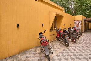 a group of motorcycles parked next to a building at Itsy Hotels Aditya in Nagpur +30 photos