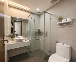 a bathroom with a shower and a toilet and a sink at 2-3 bedroom at HUD building Nha Trang in Nha Trang
