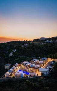 an aerial view of a large building with tents at Piccolo Paradiso - Glamping Resort in Shëngjin