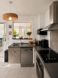 a kitchen with a sink and a counter top at TI kasa cherry in Le Diamant