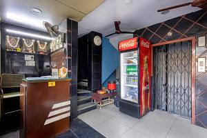a coca cola refrigerator in a restaurant at Hotel Swarna Mayuri in Guntūr
